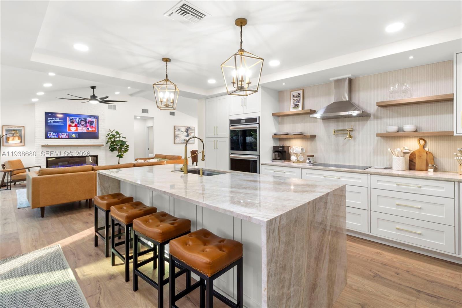 3540 Northeast 28th Avenue Lighthouse Point, FL 33064 - Photo 3 of 47 a large kitchen with a table and chairs