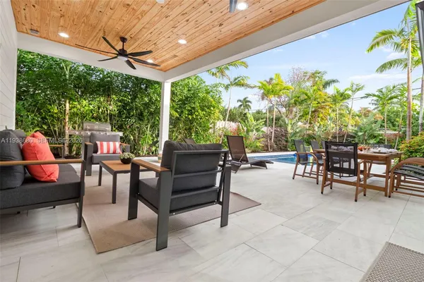 a view of a chairs and tables in the back yard of the house