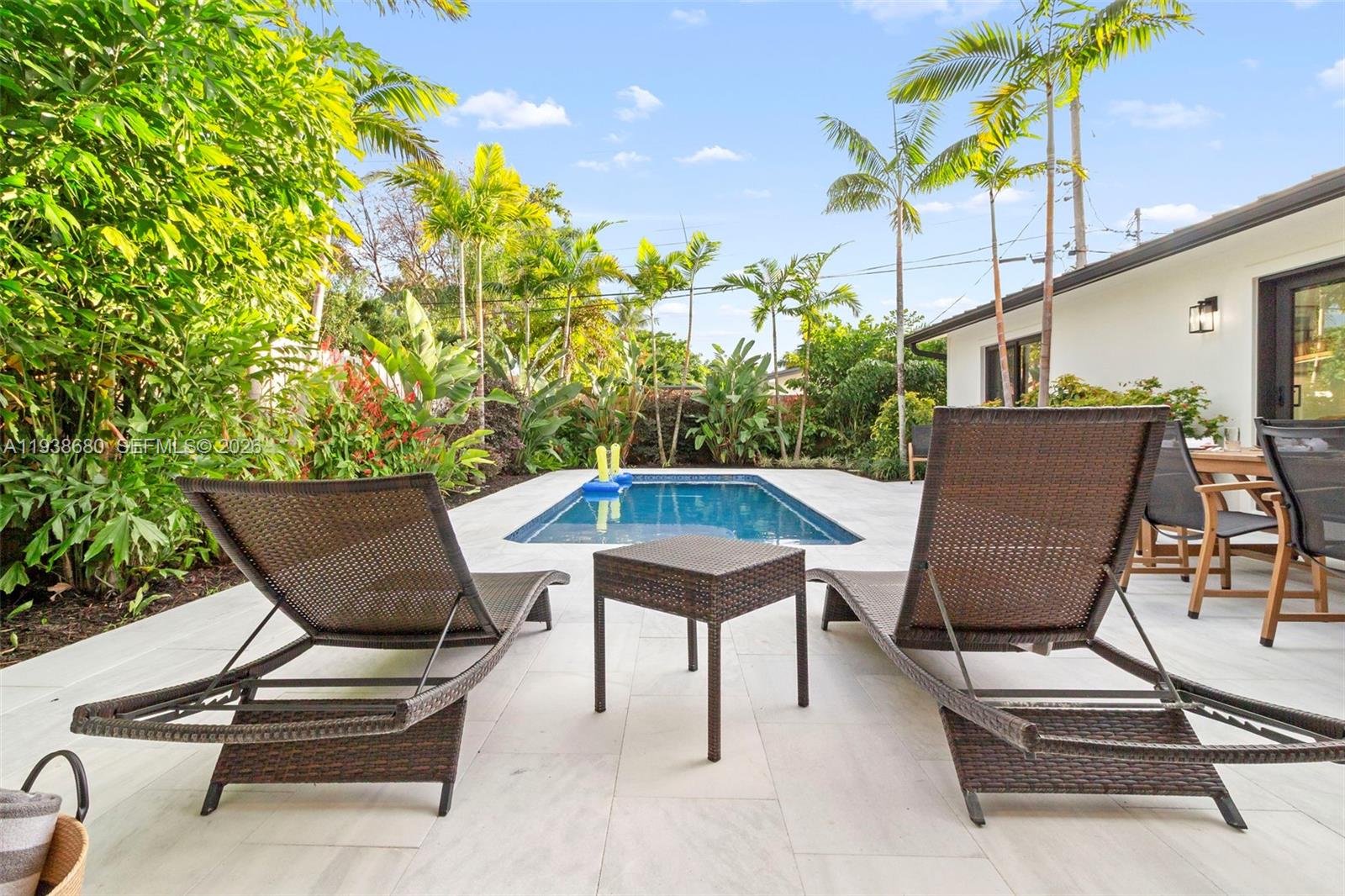 3540 Northeast 28th Avenue Lighthouse Point, FL 33064 - Photo 7 of 47 a view of a chairs and tables in the back yard of the house