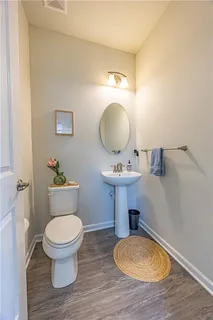 a bathroom with a toilet a sink and mirror