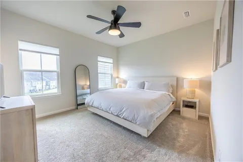 a bedroom with a bed and a window