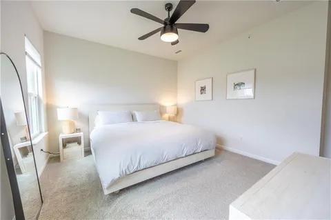 a bedroom with a bed and a large window