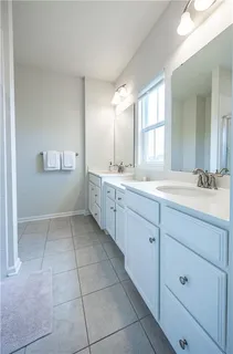 a bathroom with a sink a mirror and a vanity