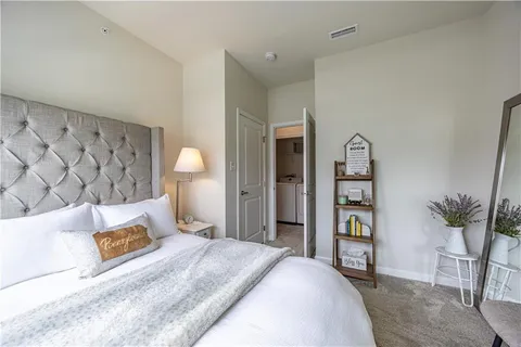 a bedroom with a bed furniture and a potted plant