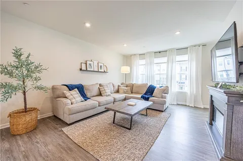 a living room with furniture rug and window