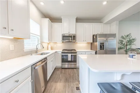 a kitchen with a stove a sink and a refrigerator
