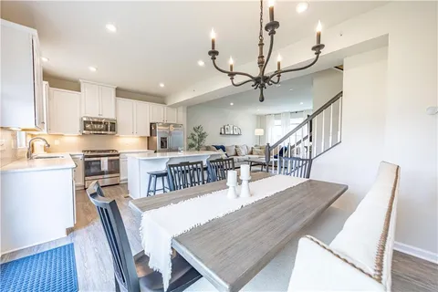 a living room with lots of furniture and a kitchen view