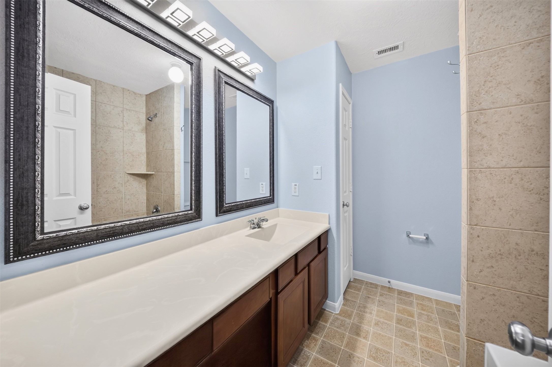 10510 Day Trail Lane Spring, TX 77379 - Photo 22 of 28 The second bathroom upstairs features an expansive countertop area, sink, dual mirrors, and tub / shower combo.