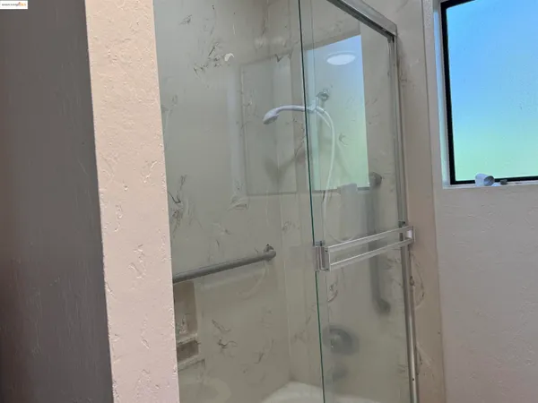 a bathroom with a glass shower door