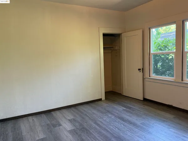 a view of a small space with wooden floor and a window