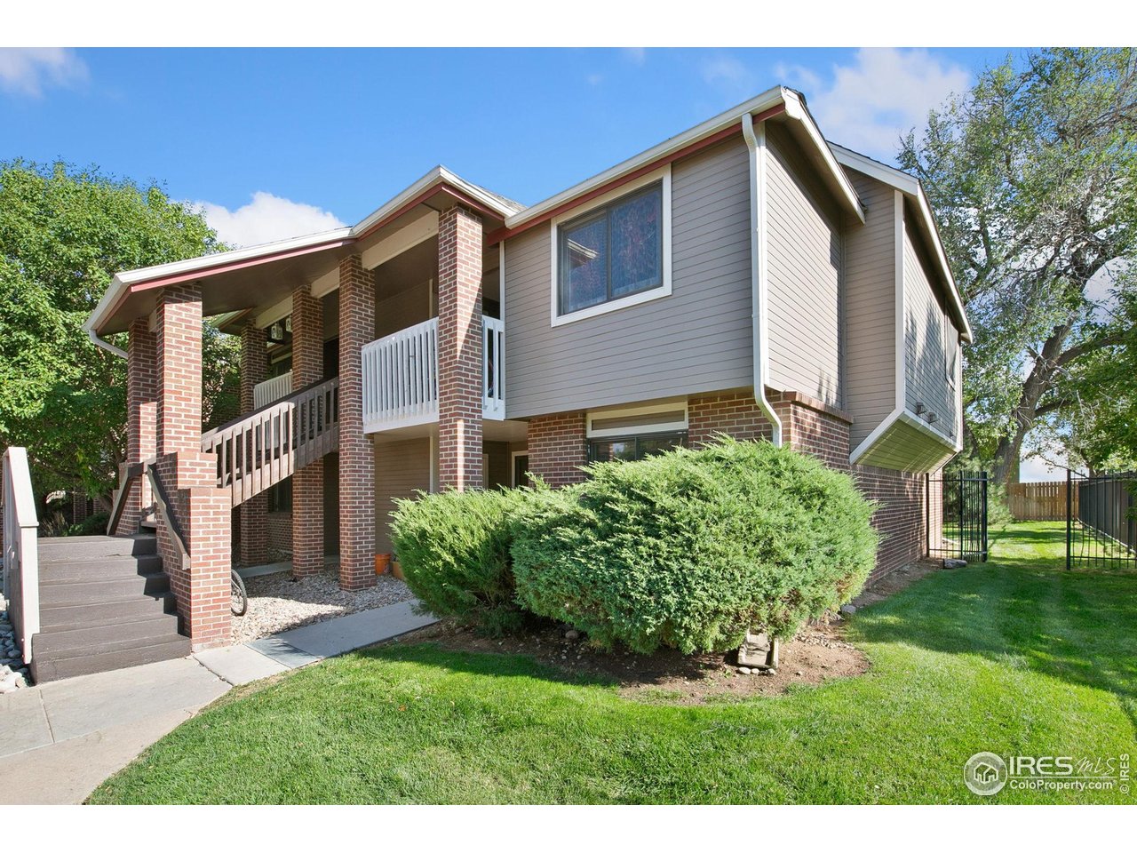 1231 West Swallow Road, Unit 316 Fort Collins, CO 80526 - Photo 1 of 42 a front view of a house with a garden
