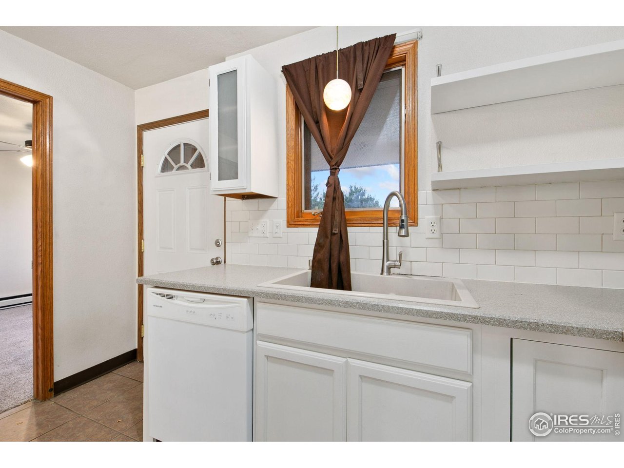1231 West Swallow Road, Unit 316 Fort Collins, CO 80526 - Photo 13 of 42 a kitchen with a sink and a mirror