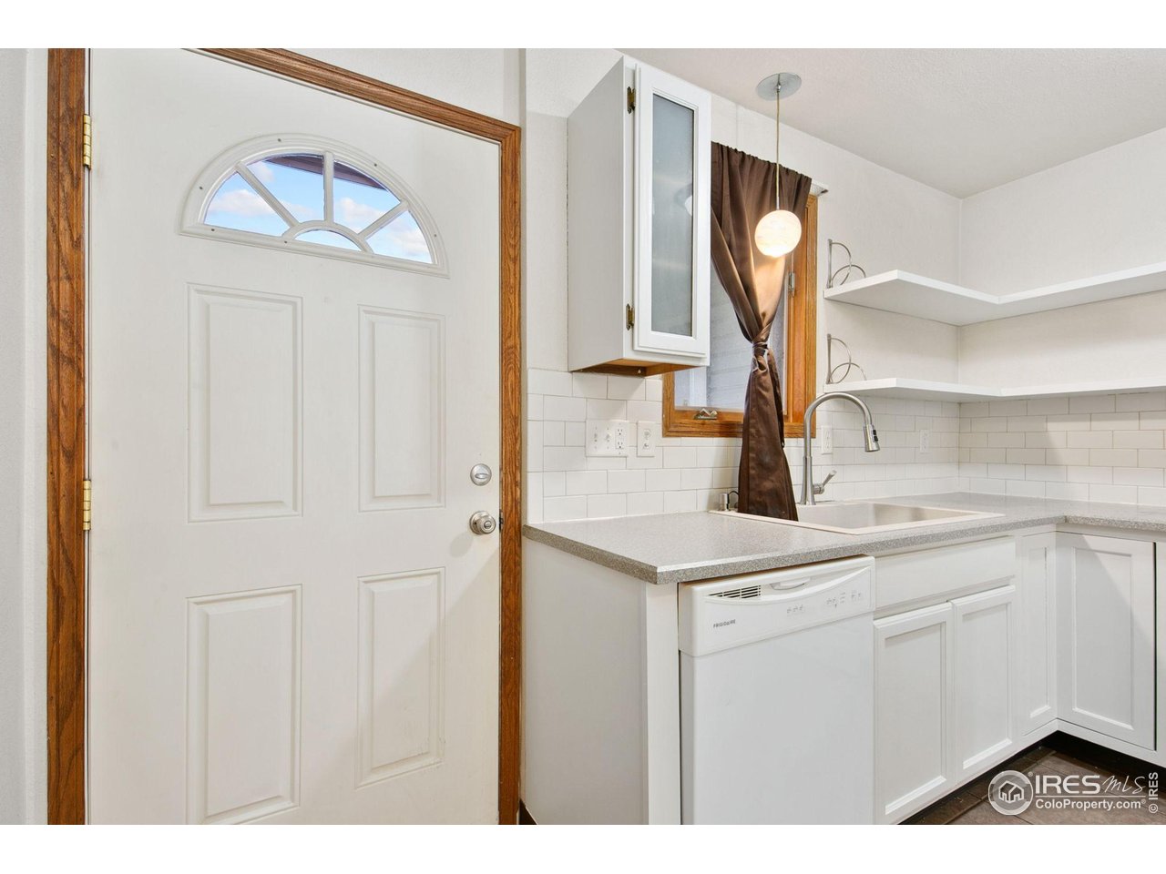 1231 West Swallow Road, Unit 316 Fort Collins, CO 80526 - Photo 14 of 42 a kitchen with a sink and a refrigerator