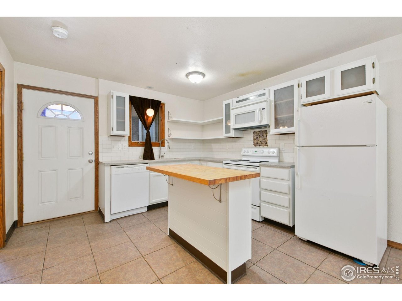 1231 West Swallow Road, Unit 316 Fort Collins, CO 80526 - Photo 15 of 42 a kitchen with white cabinets and white appliances