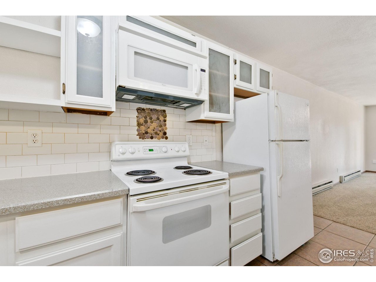 1231 West Swallow Road, Unit 316 Fort Collins, CO 80526 - Photo 16 of 42 a kitchen with stainless steel appliances white cabinets and a sink