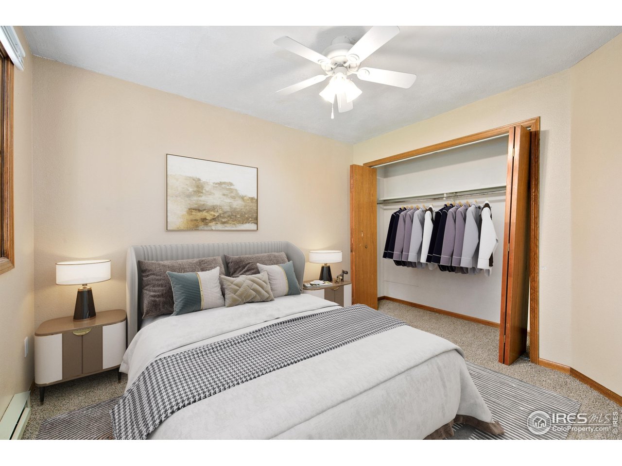 1231 West Swallow Road, Unit 316 Fort Collins, CO 80526 - Photo 29 of 42 a bedroom with a large bed and a chandelier