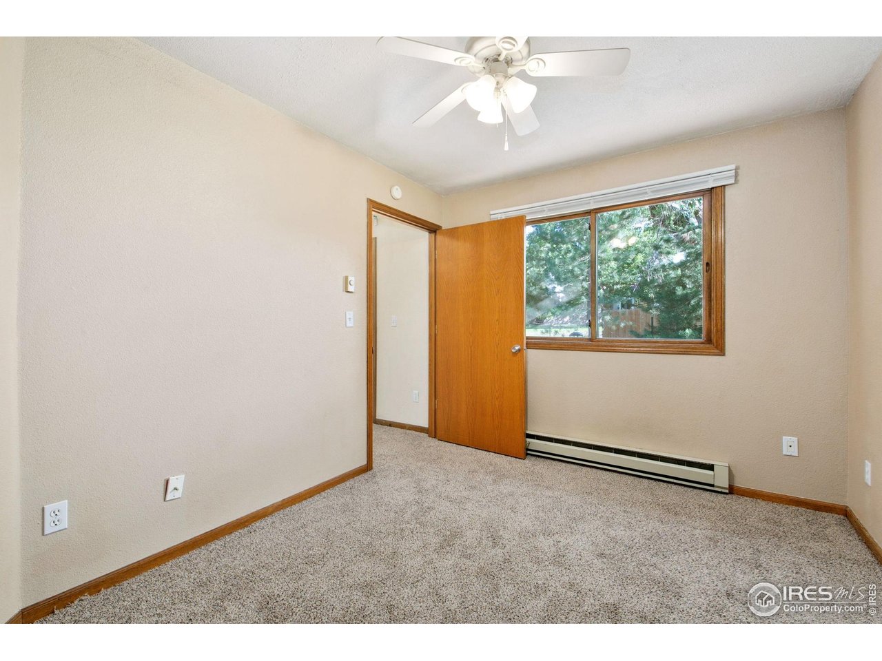 1231 West Swallow Road, Unit 316 Fort Collins, CO 80526 - Photo 31 of 42 an empty room with windows and fan