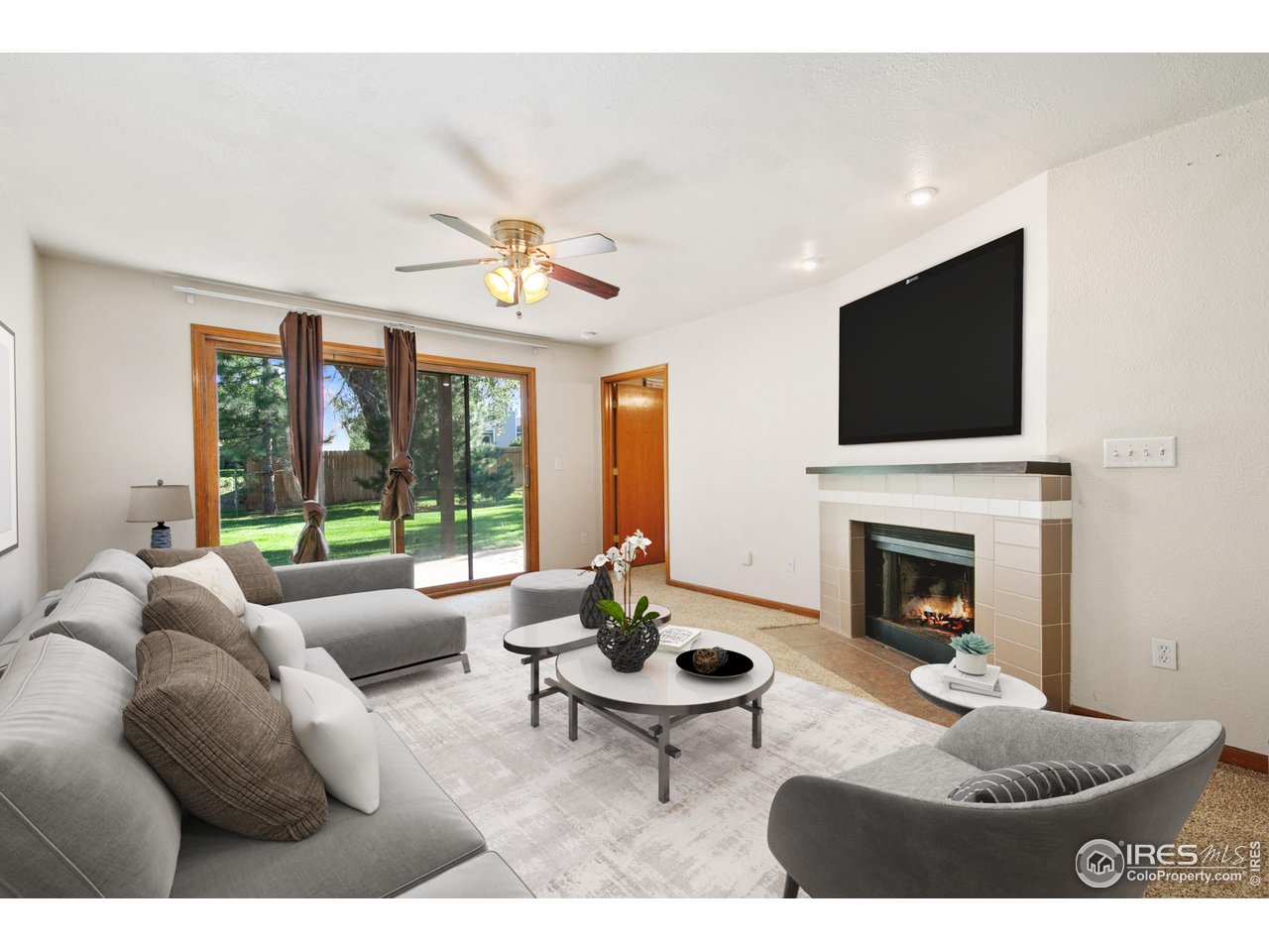 1231 West Swallow Road, Unit 316 Fort Collins, CO 80526 - Photo 7 of 42 a living room with furniture a fireplace and a flat screen tv