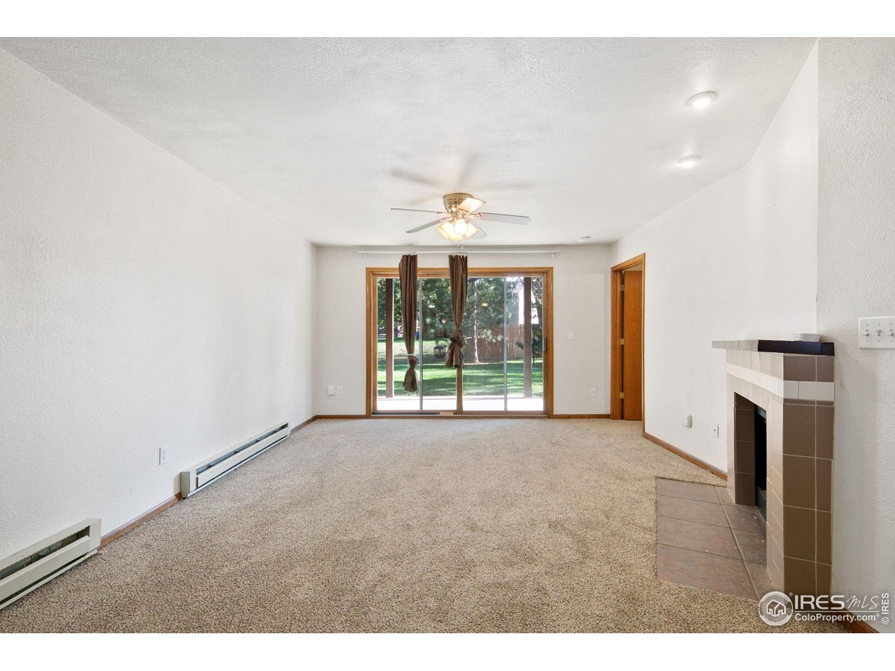1231 West Swallow Road, Unit 316 Fort Collins, CO 80526 - Photo 8 of 42 a view of an empty room with a fireplace and a window