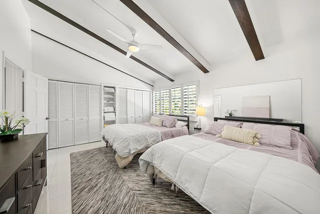 a bedroom with two beds and painted walls