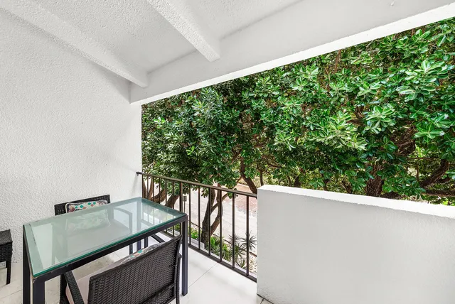 a balcony with wooden floor and outdoor space