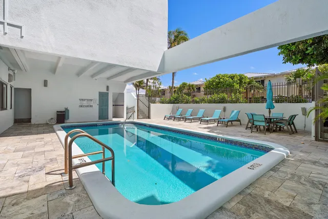 a living room with furniture pool table and chairs