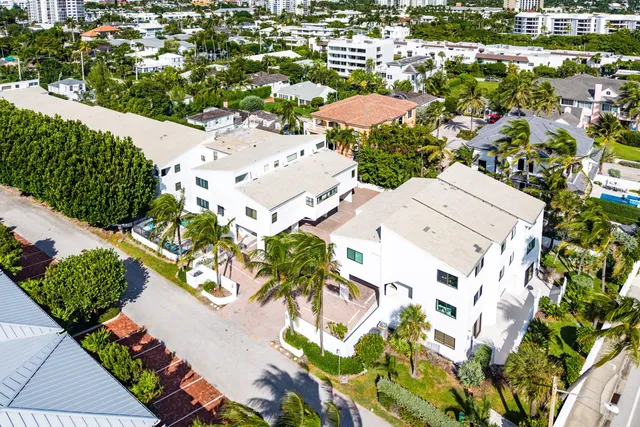 an aerial view of a residential houses with yard