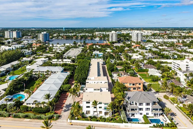 an aerial view of residential houses with city view