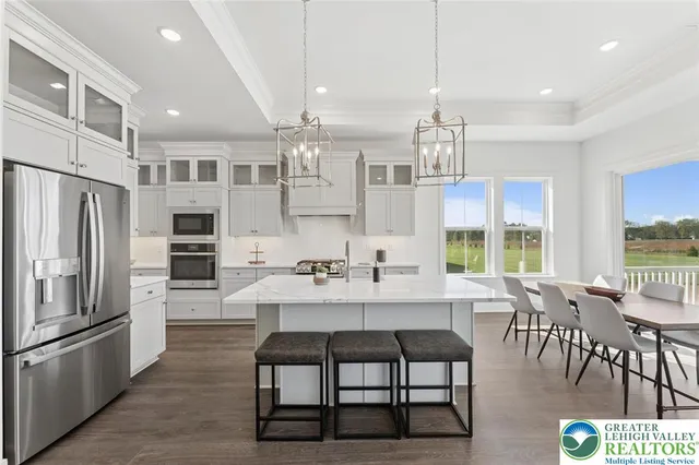 a large kitchen with a table and chairs