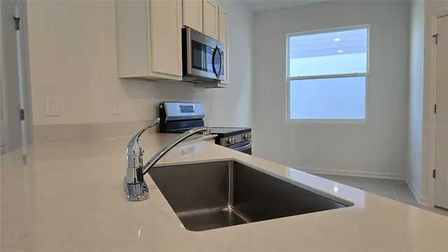 a view of a microwave and cabinets