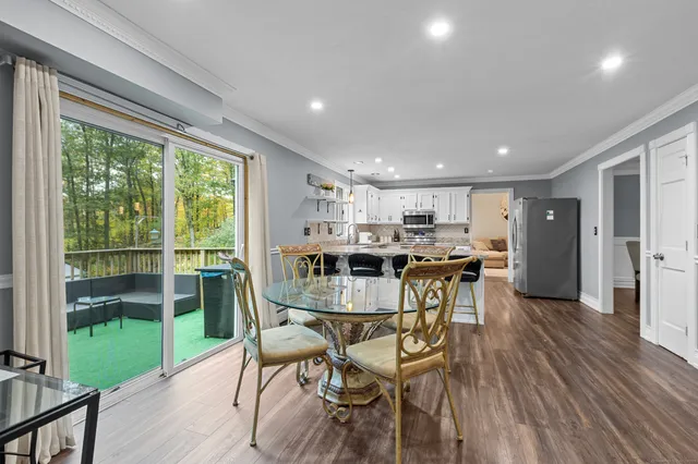 a view of a dining room with furniture window and wooden floor