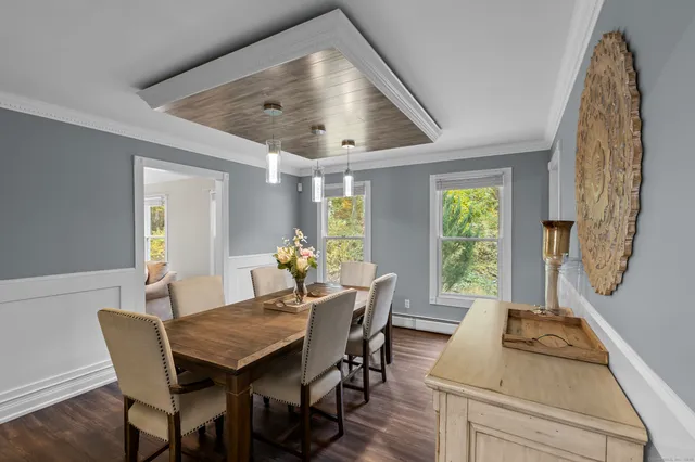 a view of a dining room with furniture and a window