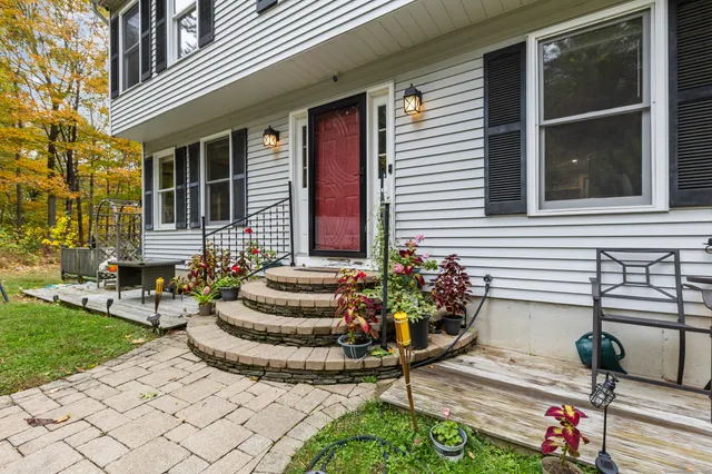 a view of house with outdoor space and sitting area