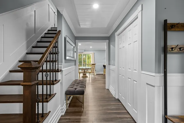 a view of entryway and hall with wooden floor