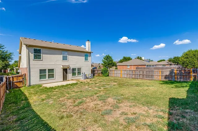 a view of a house with a backyard and a patio