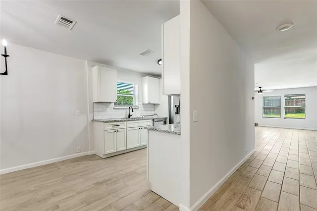 a kitchen with a refrigerator and a stove top oven