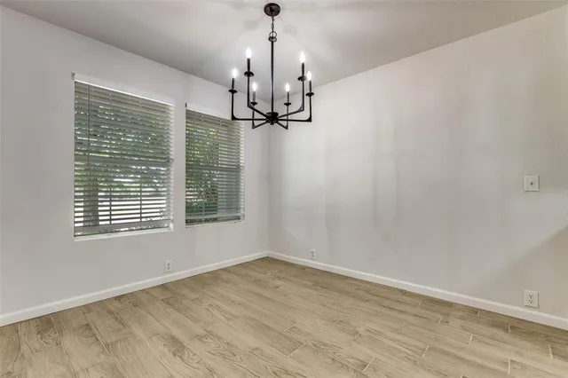 a view of a room with a window and wooden floor
