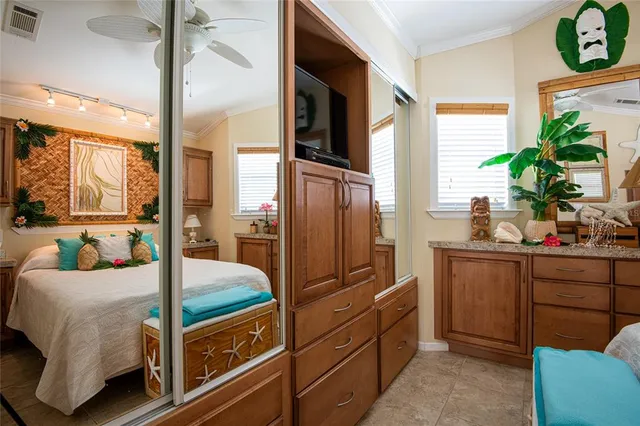 a bedroom with a bed and large windows