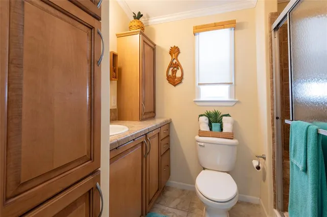 a bathroom with a toilet a sink and a shower