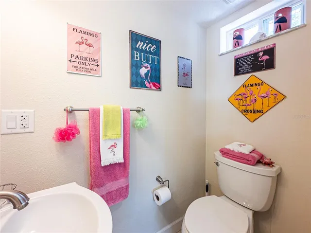 a bathroom with a sink mirror and toilet