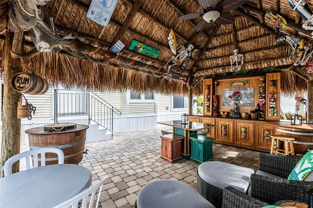 a view of a porch with chairs and potted plants