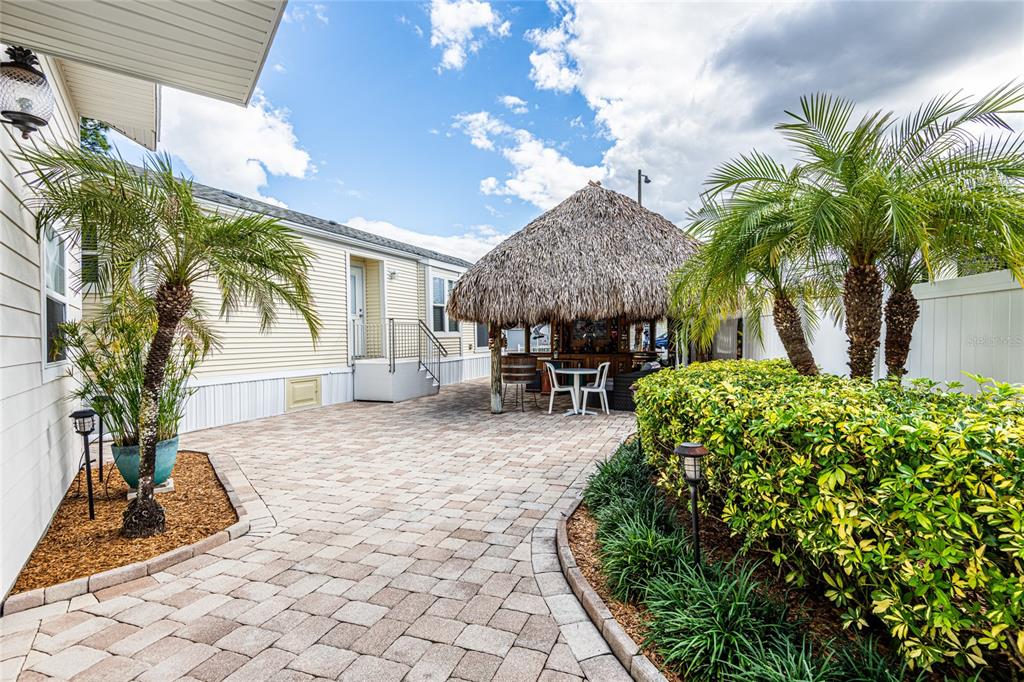 20300 Leonard Road, Unit 33 Lutz, FL 33558 - Photo 32 of 36 a view of a porch with chairs and potted plants