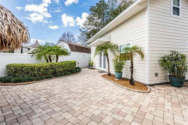 a view of a patio with a table and chairs under an umbrella with a couch