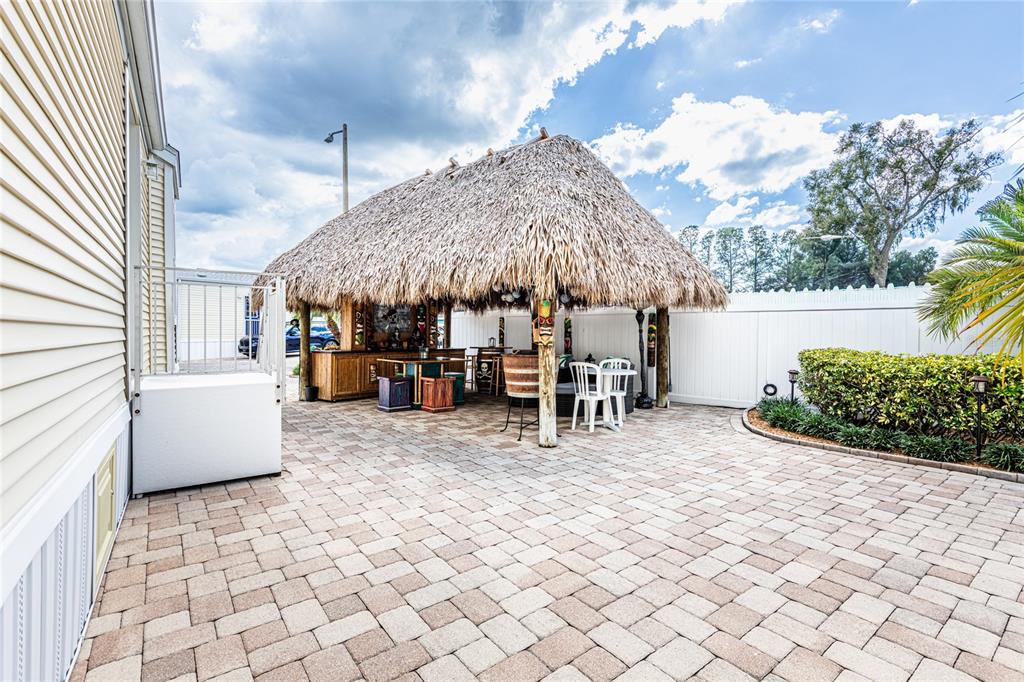 20300 Leonard Road, Unit 33 Lutz, FL 33558 - Photo 35 of 36 a view of a patio with a table and chairs under an umbrella with a couch