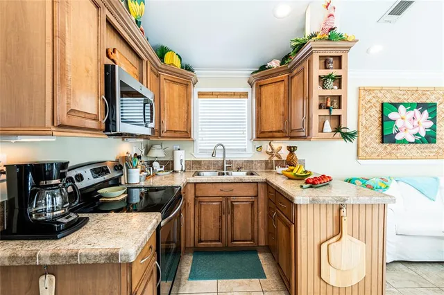 a kitchen with stainless steel appliances granite countertop a sink stove and cabinets