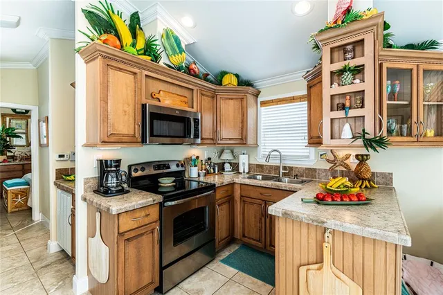 a kitchen with stainless steel appliances granite countertop a stove a sink and a microwave