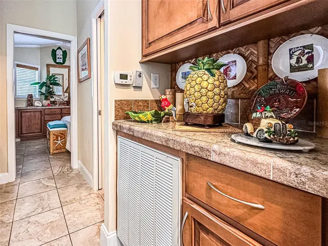 a kitchen area with granite countertop a stove and cabinets