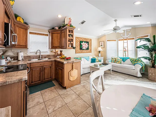 a kitchen with a sink a counter top space and stainless steel appliances