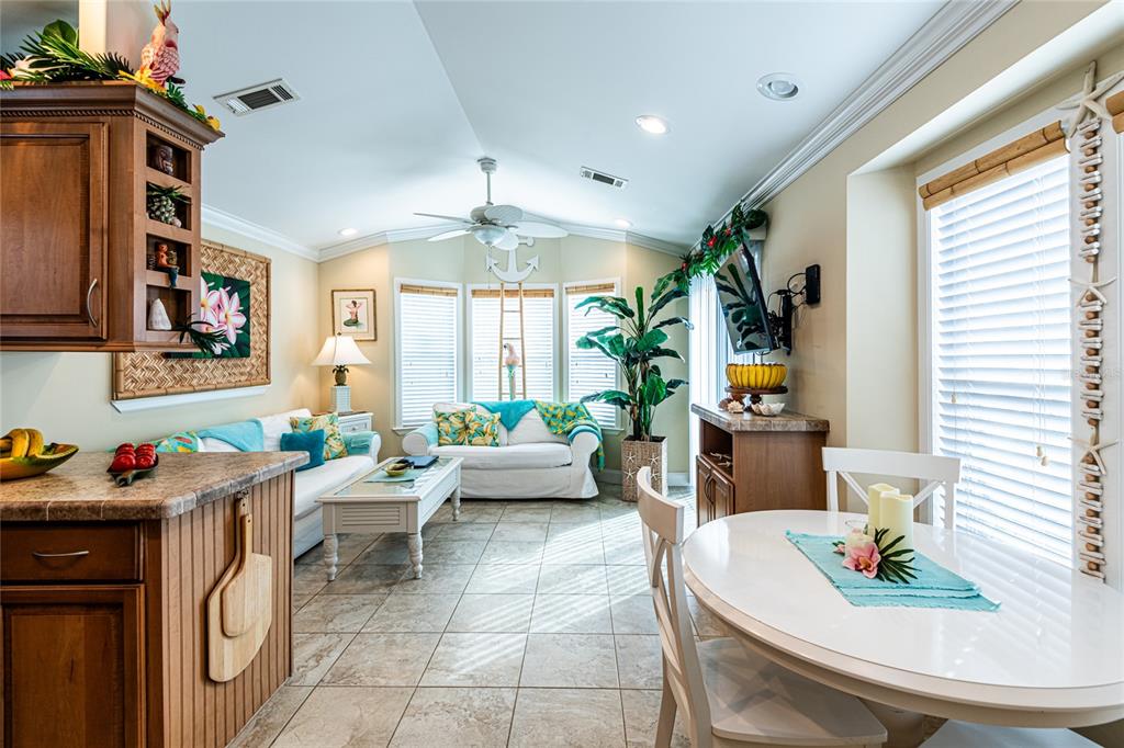 20300 Leonard Road, Unit 33 Lutz, FL 33558 - Photo 10 of 36 a living room with furniture a chandelier and a dining table
