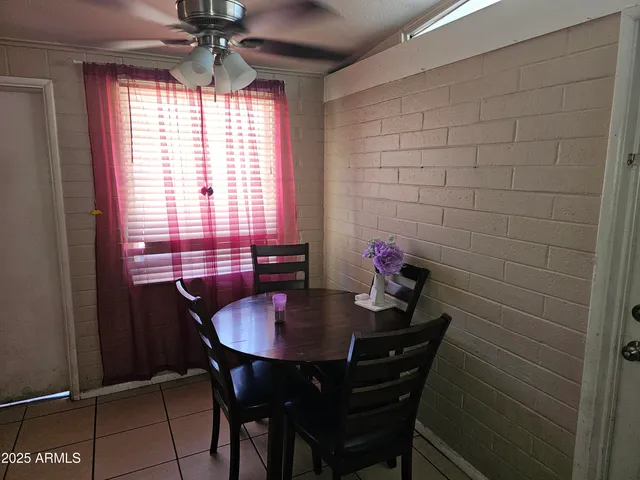 a view of a dining room with a table and chairs